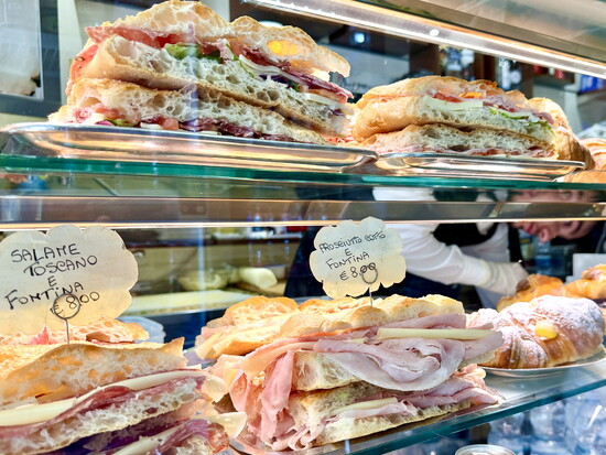 A Florentine panino is made with sciacciata (focaccia) or unsalted Tuscan bread layered with fillings like prosciutto, pecorino, grilled eggplant, and arugula.