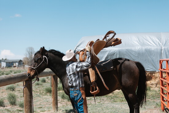 Don saddling his horse up before a ride