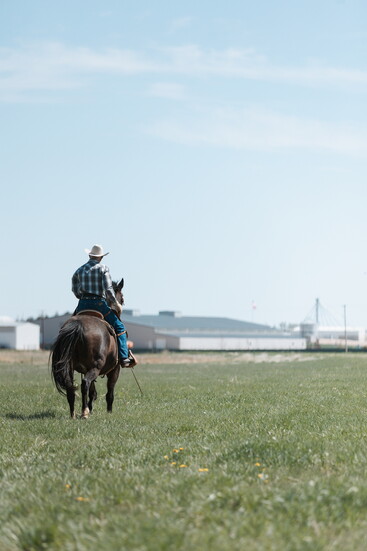 Don riding in one of his fields of grass