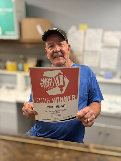 Norm proudly holds his 2026 Best Nursery/Garden Center Award