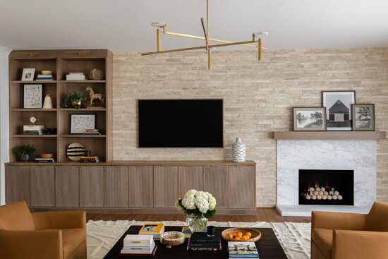V Parallels Budi Creme Honed tile from Island Stone helped balance the off-center fireplace in the Jones family living room