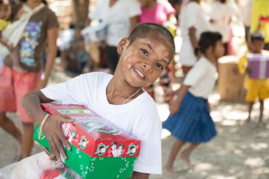 A young boy from the Philippines receives his Operation Christmas Child shoebox gift.