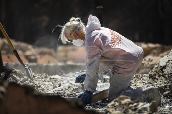 Samaritan's Purse volunteer sifting through ashes left by the West Coast wildfires in September 2020.