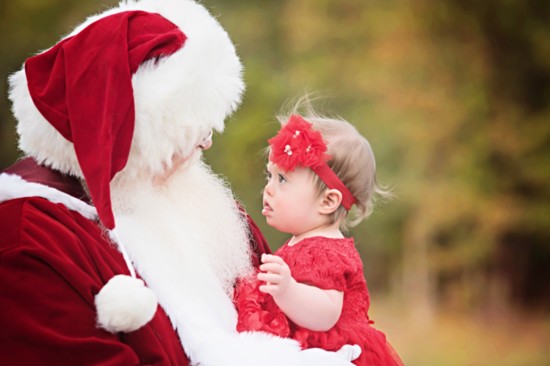 Santa asks a little child what she wants for Christmas.