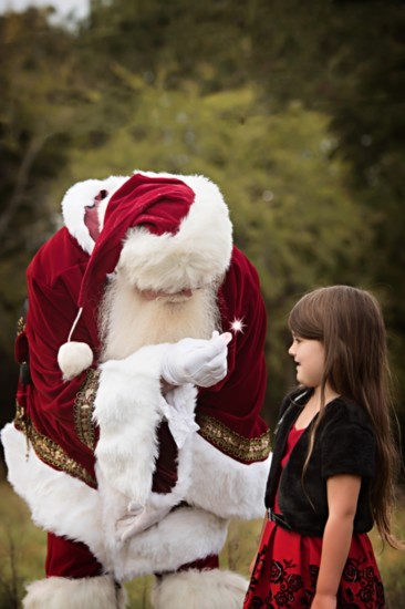 Santa shows a child the magic of Christmas.