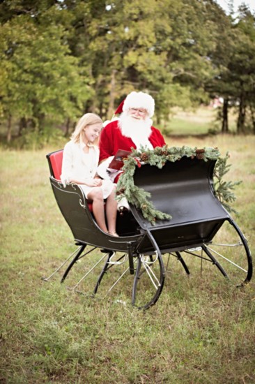 Santa reading a story while in his sleigh. 