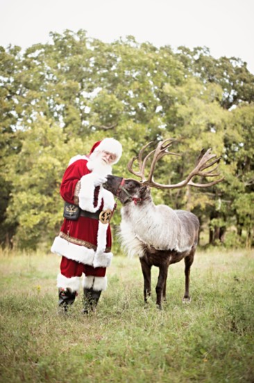 Santa discusses the Christmas night route with one of his reindeers.