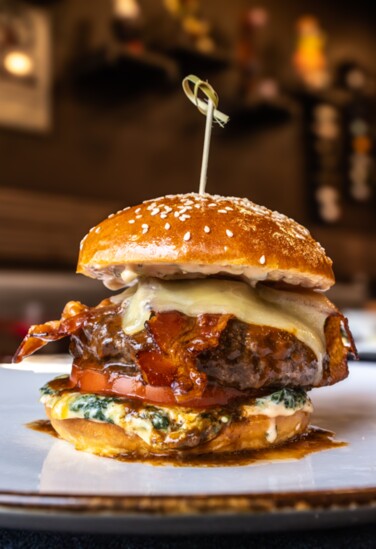 The Conche burger: Braised Beef Short Ribs, Bacon, Caramelized Shallot Jam, Sharp Vermont Cheddar,  Creamed Spinach, Tomato, Chocolate BBQ Sauce, Secret Sauce 