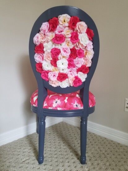 Profusions of pink, red and white flowers bloom from the back of this sassy chair