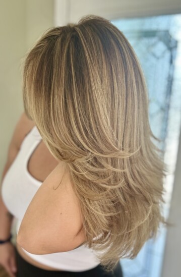 Textured layered hair cut with warm balayage. 