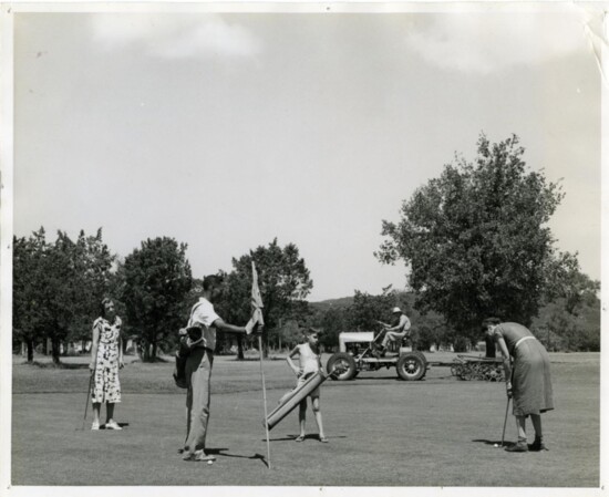 A family playing golf at 'Muny' and a lawn maintenance worker keeping the grounds in 1937.