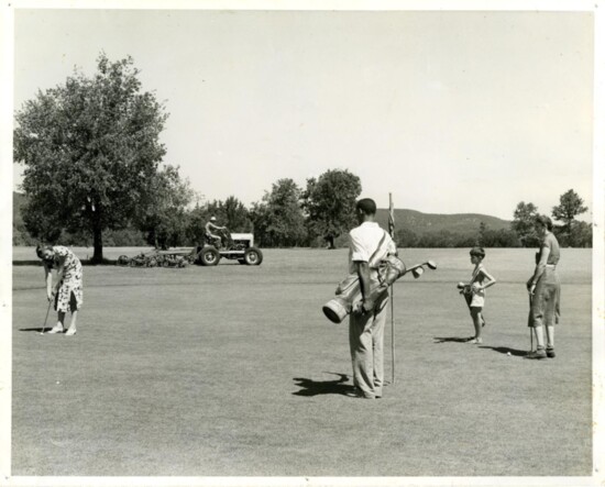 A family playing golf at 'Muny' and a lawn maintenance worker keeping the grounds in 1937.