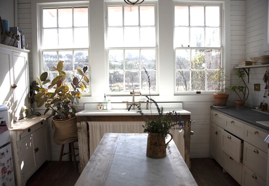 Ida House's vintage farmhouse sink bathed in morning sunlight.