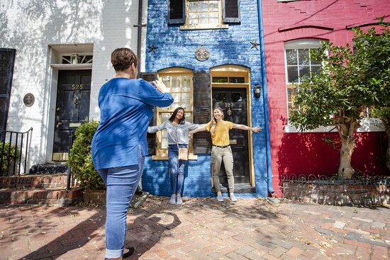 People taking pictures at Old Town Alexandria's Spite House. Photo Credit: Kristian Summerer for Visit Alexandria 