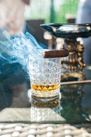 A smoky partnership occurs outside in the outdoor lounge. 