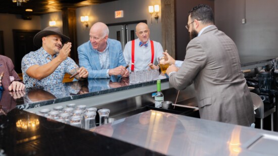 Dean Cavero, Realtor, Jeff Cleary, co-owner of Stretchzone, and Ron Turner, owner of Theory 5 enjoy their beverages at the bar. 