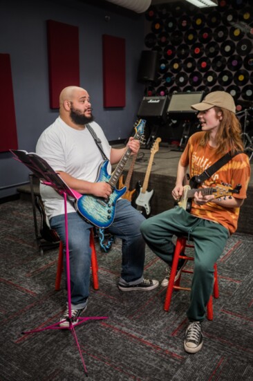 School of Rock teacher Caleb James works one-on-one with student Lyle Cidlik.