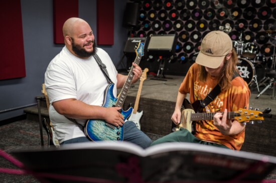 School of Rock teacher Caleb James works one-on-one with student Lyle Cidlik.