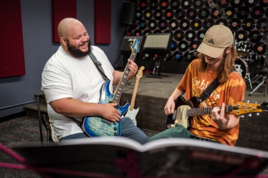 School of Rock teacher Caleb James works one-on-one with student Lyle Cidlik.