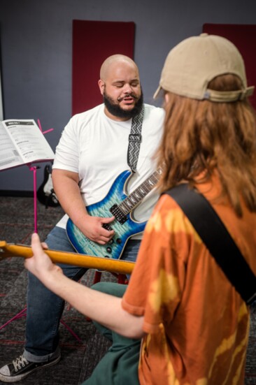 School of Rock teacher Caleb James works one-on-one with student Lyle Cidlik.