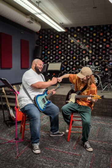 School of Rock teacher Caleb James works one-on-one with student Lyle Cidlik.