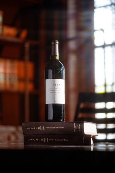 Veritas wine on a stack of books. Photo Credit: Jeremy Chapline/@thecharredcask 