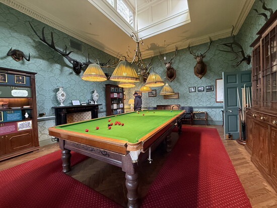 A full-sized antique snooker table in the billiards and game room at the Inverlochy Castle Hotel.