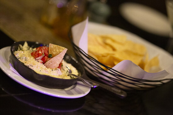 The Scratch Spinach Dip comes in a skillet and is topped with parmesan cheese and house-made pico de gallo.