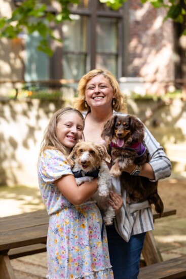 Nicole Stahl holding Daisy, and Zoey holding Hans.