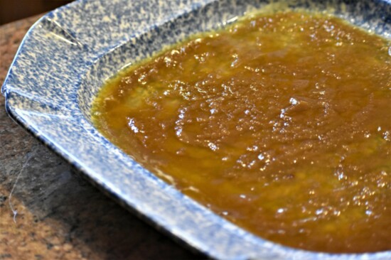 Layer baking pan with melted butter and brown sugar.