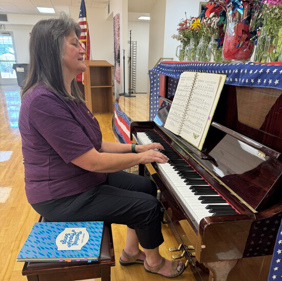 Mary Ann playing piano for seniors