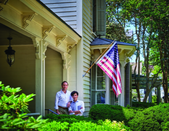 Tom and Felipe Fisher stand on the porch of their home, the John Knox house, built in 1871 and situated on a prominent street in Salisbury’s West Square 