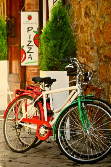 A Pair of Bikes Outside of a Pizzeria in Italy