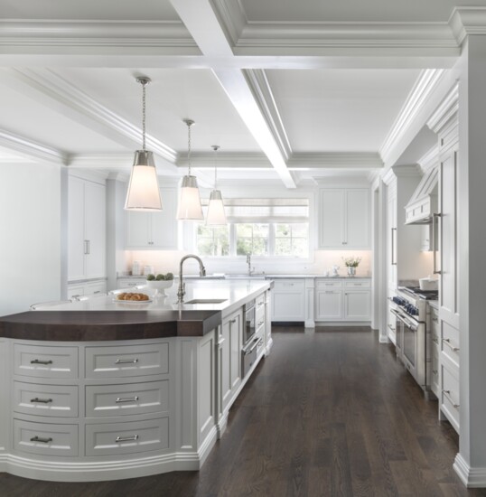 Tucked into the kitchen nook is an extra-large square concrete table, custom-made in North Carolina, surrounded by bench seating plus six additional chairs. “It