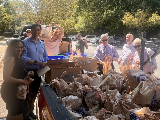 A truckload of blessings—Smyrna Rotary members celebrate after filling hundreds of bags with food for local children in need.