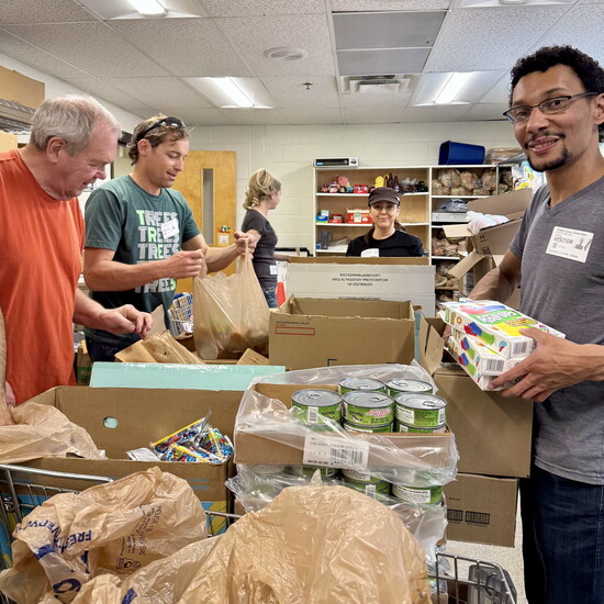 Hands and hearts at work—Rotarians sort donated goods and pack them with gratitude for Backpack Buddies.