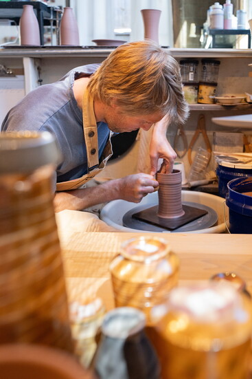 Drake Bialecki is a potter at Mud Lake and runs his business,  Pacific Stone Pottery, from his corner studio. 