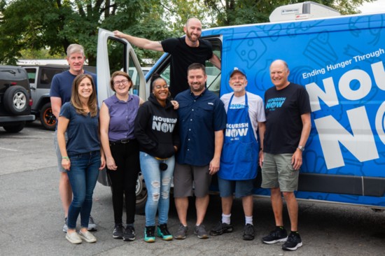 The NourishNow corporate team led by team lead Brett Meyers. NourishNow is a nonprofit food bank where local families can pick up a five-day supply of food. 