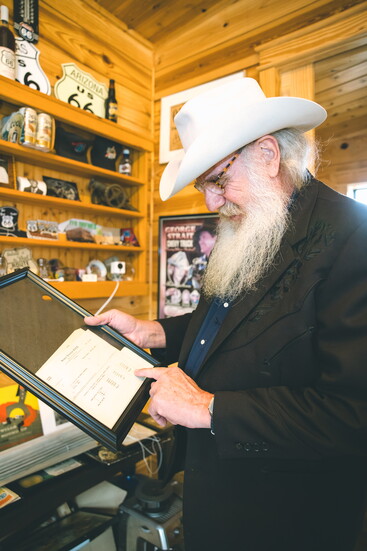 Benson showing part of his memorabilia - a Bob Wills recording session receipt from the 1930s