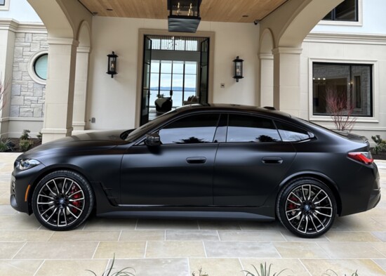 2023 BMW i4 M50 Performance Gran Coupe in Frozen Black exterior at The Lakehouse on Mercer Island represented by Team Foster of Compass