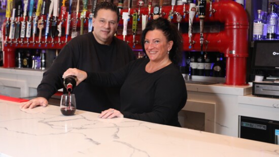 Tony and Maria Prifitera behind the bar at their Sicily Coal Fired Pizza restaurant. 