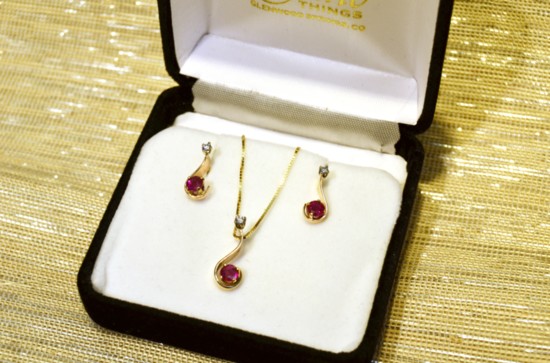 14K ruby pendant and earring set with diamond accents.
