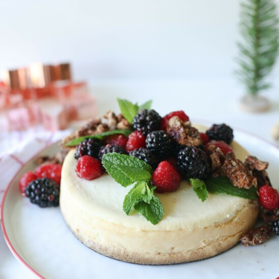 A New York style cheesecake from Trader Joe's can be a holiday centerpiece when dressed up with berries, candied pecans and fresh mint sprigs. 
