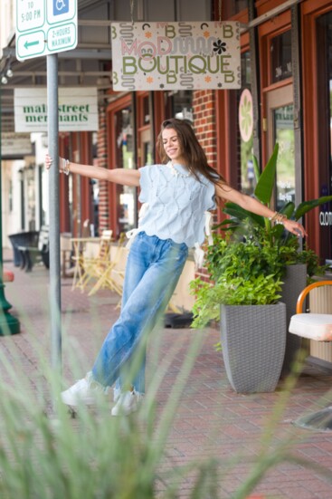 Jeans are always a must have paired with a cable knit sweater vest with a bow tie and white platform sneakers and pearl jewlery-all from Mod Boutique. 