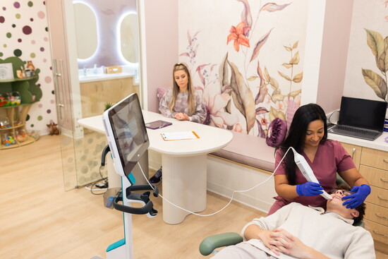 Thoughtfully designed treatment room with a dedicated parent seating and table area.