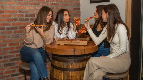 From L-R, Sara, Carly, Madison and Julia Shapiro eating pizza at The Beam House. 