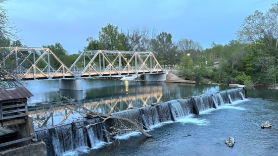 Always scenic, the lighted bridge on the Finley River adds a romantic note for diners at The Ozark Mill.
