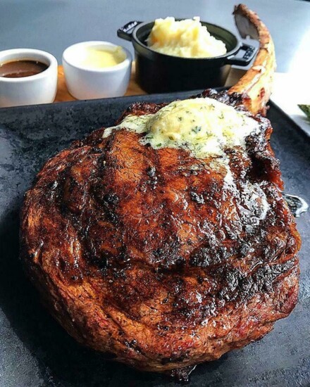 seared cowboy-cut ribeye steak with herb compound butter potatoes mousseline