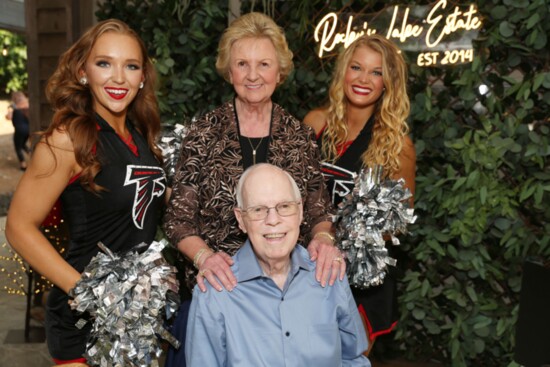 Janice and Pat Vinson, founders of Kids 'R' Kids and big supporters of Sunshine enjoy time with the Falcons cheerleaders