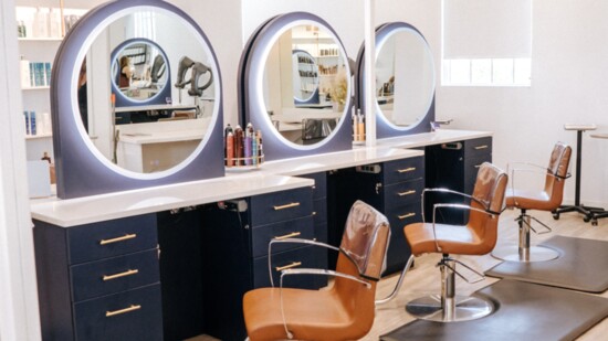 The salon space is warm and inviting for a client-centered experience.